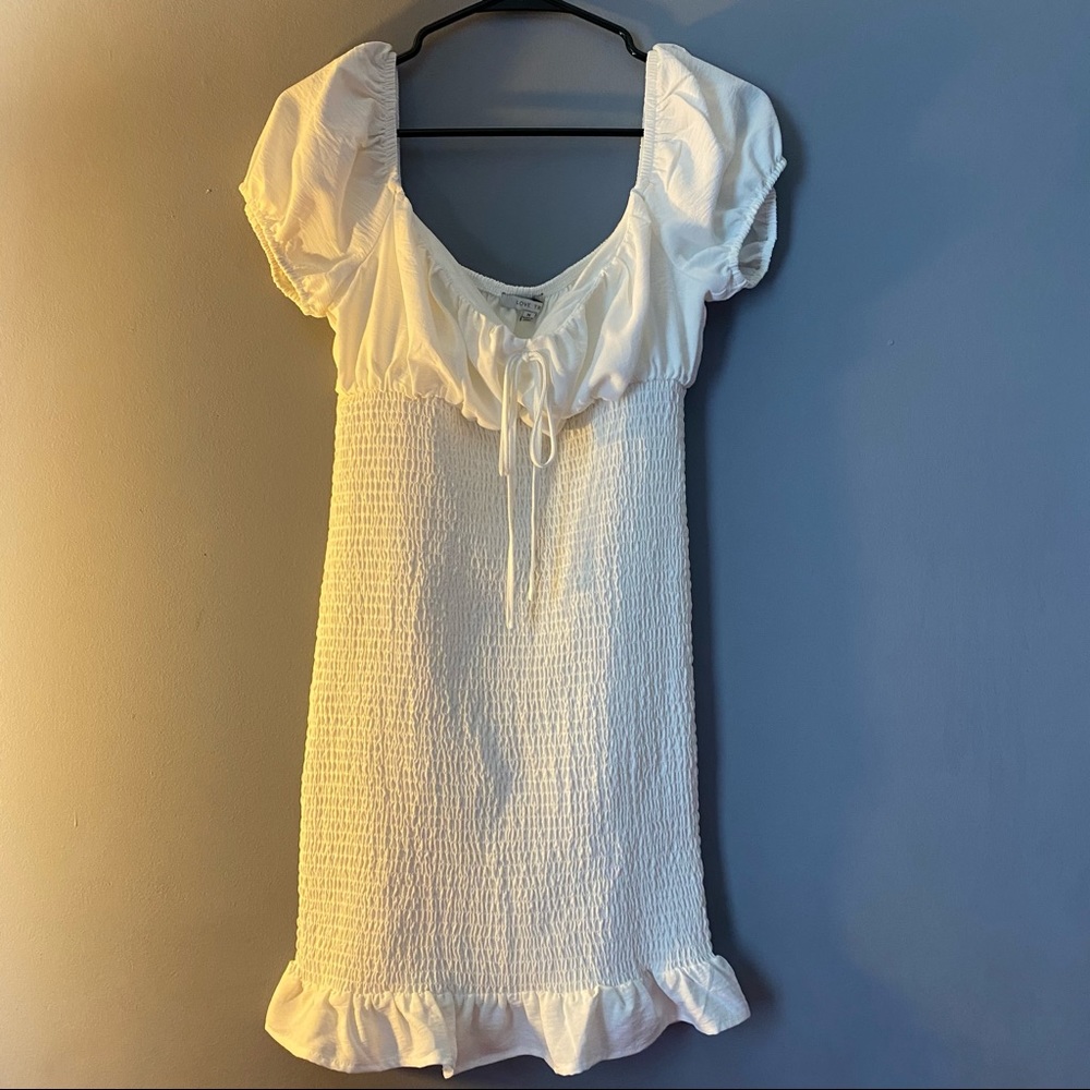 White ruffle trim dress . Size medium . Worn once
